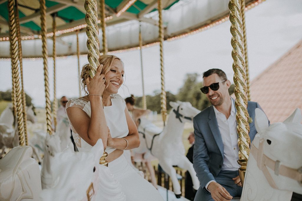 bride & groom on carousel at preston court